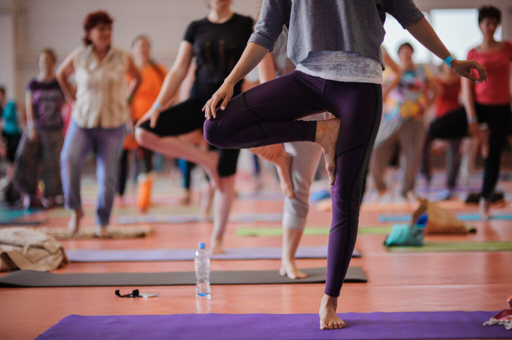 Women practicing yoga at health club