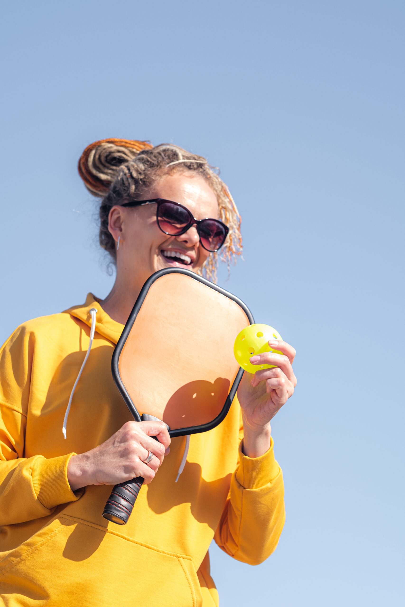 Portrait woman player pickleball game, pickleball yellow ball with paddle, outdoor sport leisure activity.